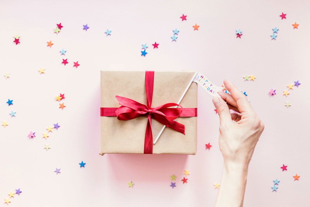crop-hand-putting-flag-present