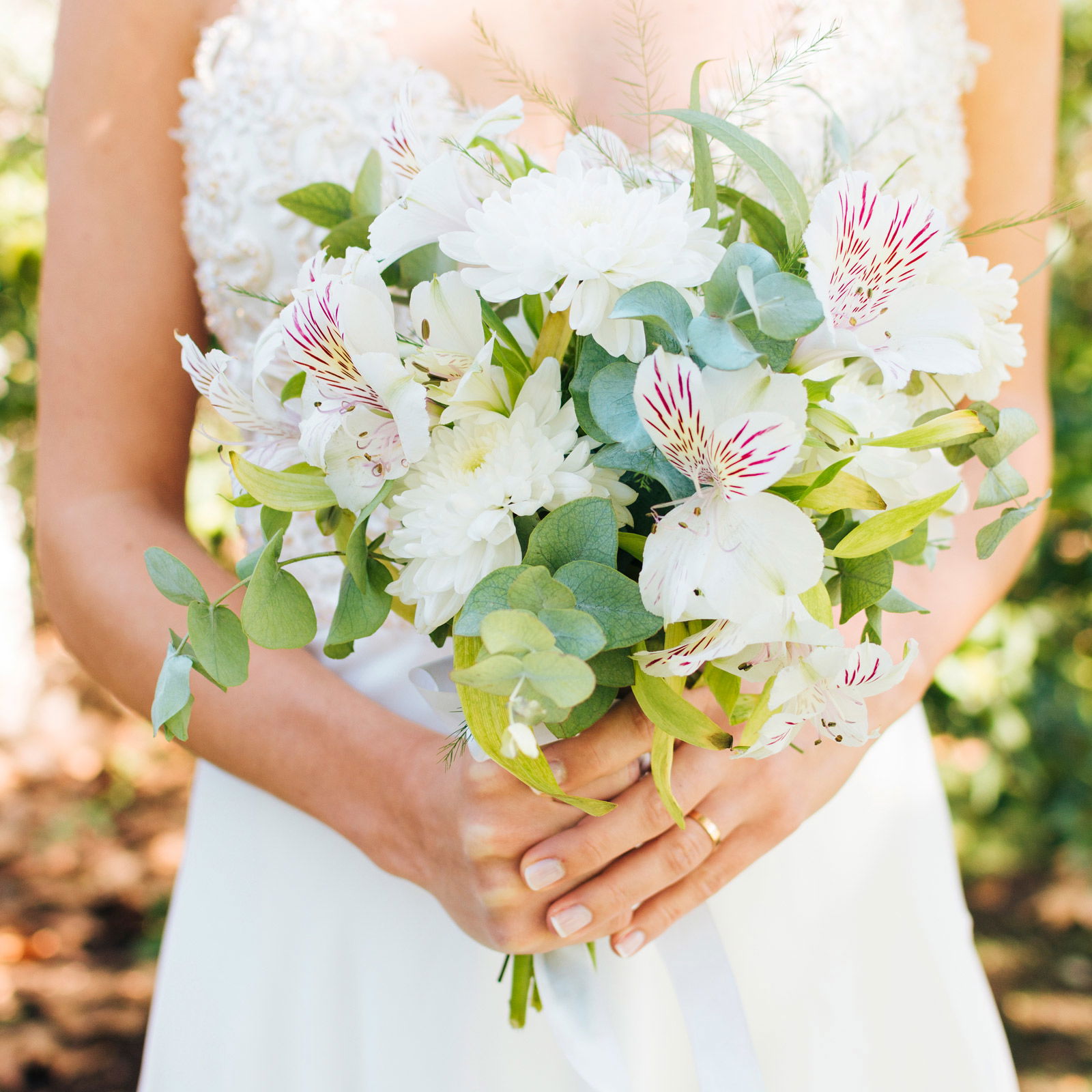 mid-section-bride-s-hands-holding-beautiful-flower-bouquet
